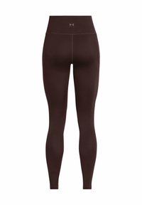 Rudos aukštai juosmeniai legginai pagaminti iš elastingos medžiagos, pasižymintys lygiu paviršiumi, prigludusia forma ir minimaliais siūlių detalėmis.