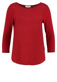 Rode langekim shirt met een ronde hals en een ontspannen pasvorm. Gemaakt van een soepele stof, met een afgeronde zoom en minimale details.