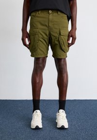 Olive green cargo shorts with a relaxed fit, two large side pockets, and a button closure; fabric appears durable and textured.