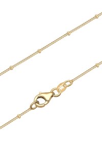 Guldtonet halskæde med en delikat kæde af ledninger med små runde accenter og en lobster clasp-lukning. Glat tekstur og blank finish.