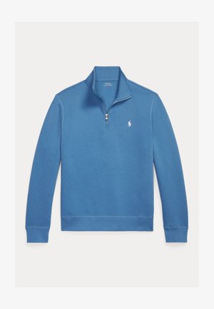 Svetlo modra pulover s četrtinskim zadrgo, narejen iz mehke mešanice bombaža, s rebrastimi manšetami in spodnjim robom ter majhnim vezenim logotipom na prsih.
