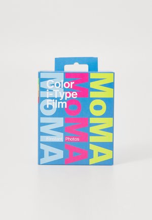 Color i-Type Film package, rectangular cardboard box, bright blue with large "MOMA" text in pink, yellow, and light blue, holds 8 instant photos.