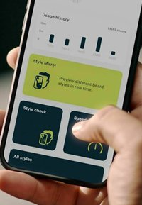 Smartphone screen displays app interface with a dark blue background, green accents, and icons for beard style preview and usage history.