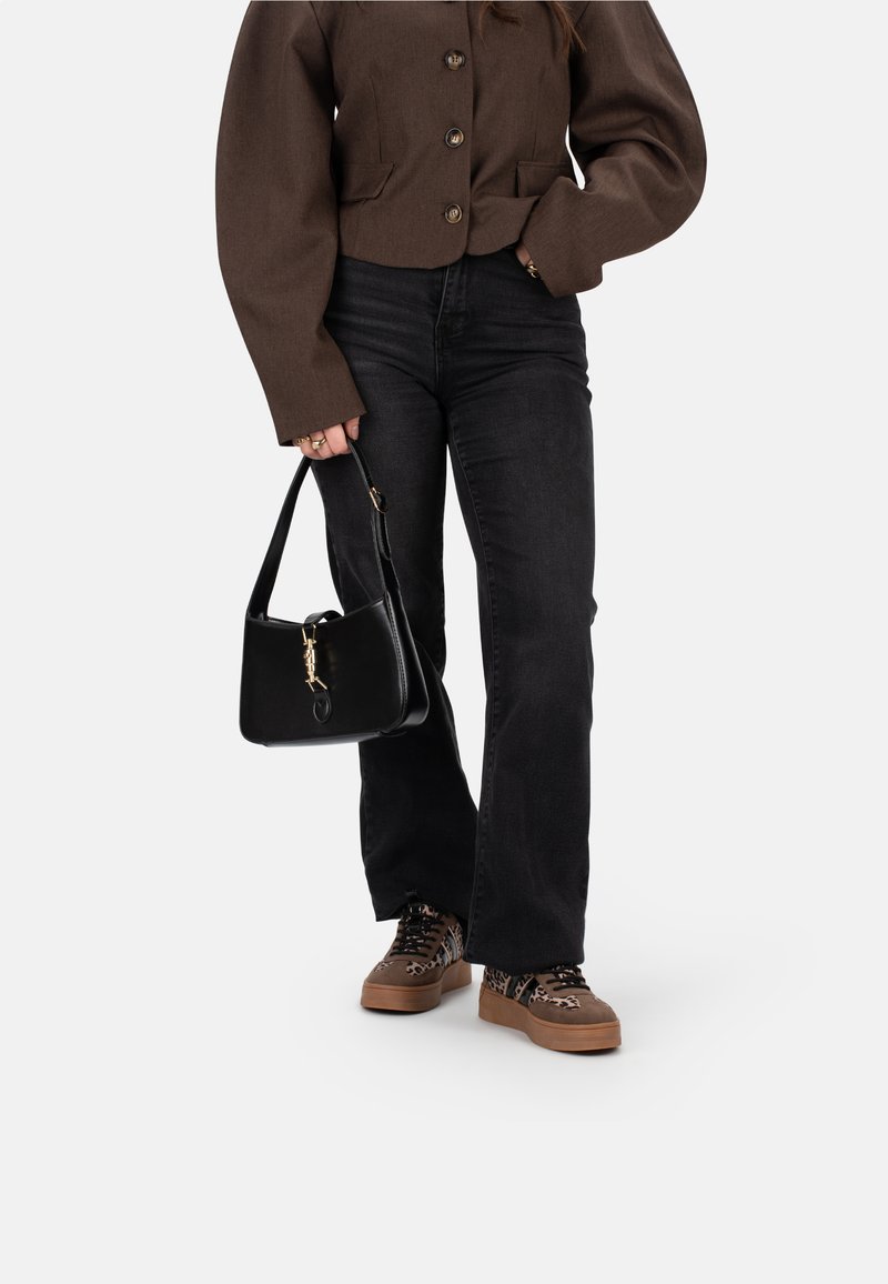Brown cropped jacket with button front, black flared jeans, leopard print sneakers, and a small black handbag with gold hardware accents.