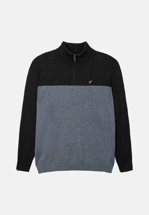 Black and grey zip-neck sweater with a ribbed collar, featuring a solid black upper section and a textured grey lower section. Gold logo accent.