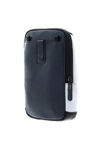 Borsa compatta con un esterno in pelle nera liscia, dotata di una tasca con zip e un piccolo anello sul retro per l'attacco a cinture o borse.