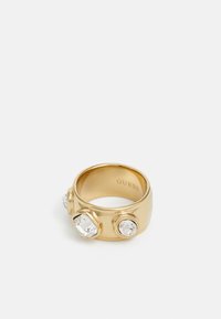 Gold ring featuring three clear, geometric crystals embedded on a smooth, polished band. Inside, "GUESS" is engraved.