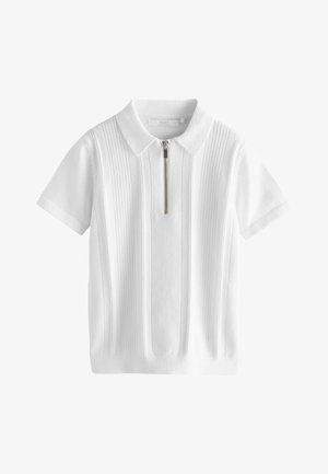 Balts īsroku polo krekls ar rāvējslēdzēja apkakli, ar vertikālu ribbed tekstūru un kontrastējošiem adījuma elementiem.