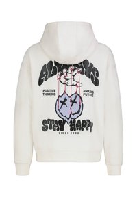 Witte hoodie met een grafisch ontwerp op de achterkant, met een hand die twee paarse elementen met stiksels controleert, en tekst die "Stay Happy" zegt.