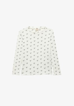 Long-sleeve white shirt made of soft fabric, featuring a repeating black bow pattern and a rounded neckline with a scalloped hem.