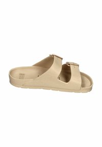 Beige slide sandal made of soft material, featuring two adjustable straps with buckles and a textured footbed for comfort.
