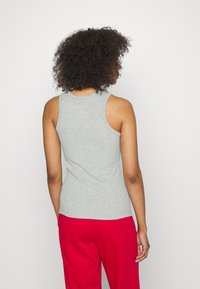 Gray, sleeveless tank top made from a soft cotton blend, features a fitted design with a round neckline and smooth texture.