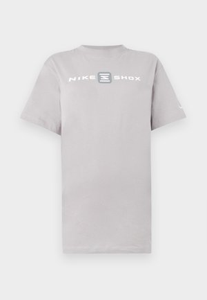 Light gray cotton t-shirt featuring a round neck and short sleeves, with "NIKE SHOX" printed in bold white letters across the chest.
