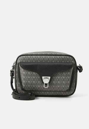 Compact rectangular bag in grey textured material, featuring a black leather flap and silver buckle closure. Includes an adjustable strap.