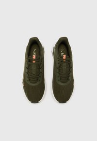 Olive green athletic shoes with mesh upper, textured laces, contrasting coral accents, and white outsole. Designed for comfort and support.