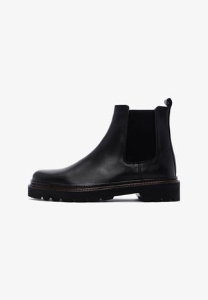 Bottines Chelsea en cuir noir avec des panneaux latéraux en élasthanne, bout rond et semelle en caoutchouc texturé. Détails de couture discrets le long du bord.