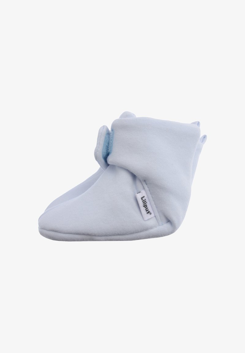 White cotton booties with a soft texture, featuring a velcro closure and small fabric tabs. Brand label visible on the side.