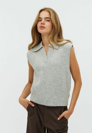 Grey ribbed sleeveless sweater with a collared neckline, made of soft knit material, paired with brown wide-leg trousers.