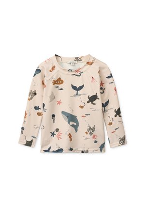 Camicia a maniche lunghe color beige chiaro con stampe colorate a tema marino, inclusi balene, tartarughe ed elementi sottomarini. Tessuto morbido e liscio.