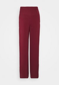 Pantalons bordeaux avec une coupe droite, taille élastique et deux poches au dos. Tissu lisse au toucher doux.