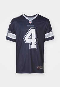 Tengerészkék NFL mez V-nyakkal, fehér díszítéssel, 4-es számmal és "COWBOYS" logóval az elején. Lélegző anyagból készült.