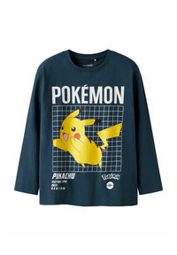 Navy long-sleeve t-shirt made of cotton, featuring a large yellow Pikachu graphic, grid background, and white text “POKÉMON” and details below.