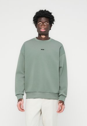 Green sweatshirt with a rounded neckline and ribbed cuffs; features a black 'BOSS' logo on the chest; made of soft material.