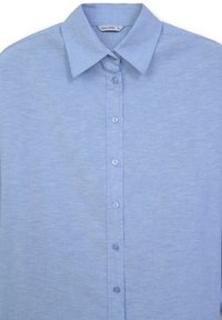 Light blue button-up shirt made of a soft, textured fabric. Features a classic collar and six buttons down the front.
