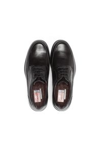 Chaussures en cuir noir avec une finition lisse, présentant un design à lacets, un bout rond et une semelle intérieure texturée. L'intérieur affiche un marquage de la marque.