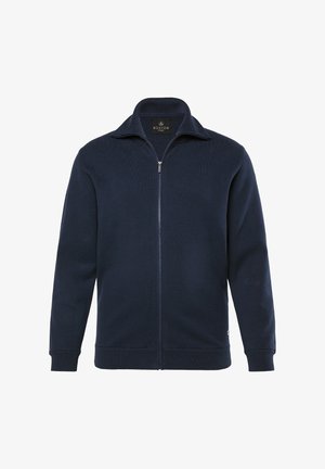 Granatowa bluza zapinana na zamek, wykonana z dzianiny, z podniesionym kołnierzem oraz ściągaczami przy mankietach i u dołu, z metką z logo na dolnym boku.