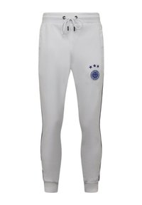 Witte joggerbroeken van een gladde stof, met een marineblauwe accentstreep, een verstelbare tailleband en een rond logo met vier sterren.