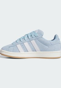 Light blue suede sneaker with white leather stripes, round toe, and textured rubber sole. Features flat laces and perforated detailing.