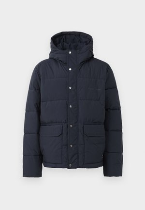 Navy puffer jacket with a hood, featuring snap buttons, two front pockets, and stitched panels for insulation. Smooth texture, warm design.
