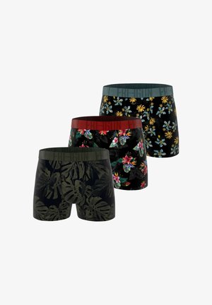 Trois paires de boxers avec des motifs floraux et de feuilles contrastants. Les couleurs incluent le noir, le vert et le rouge, avec des ceintures élastiques arborant du texte.