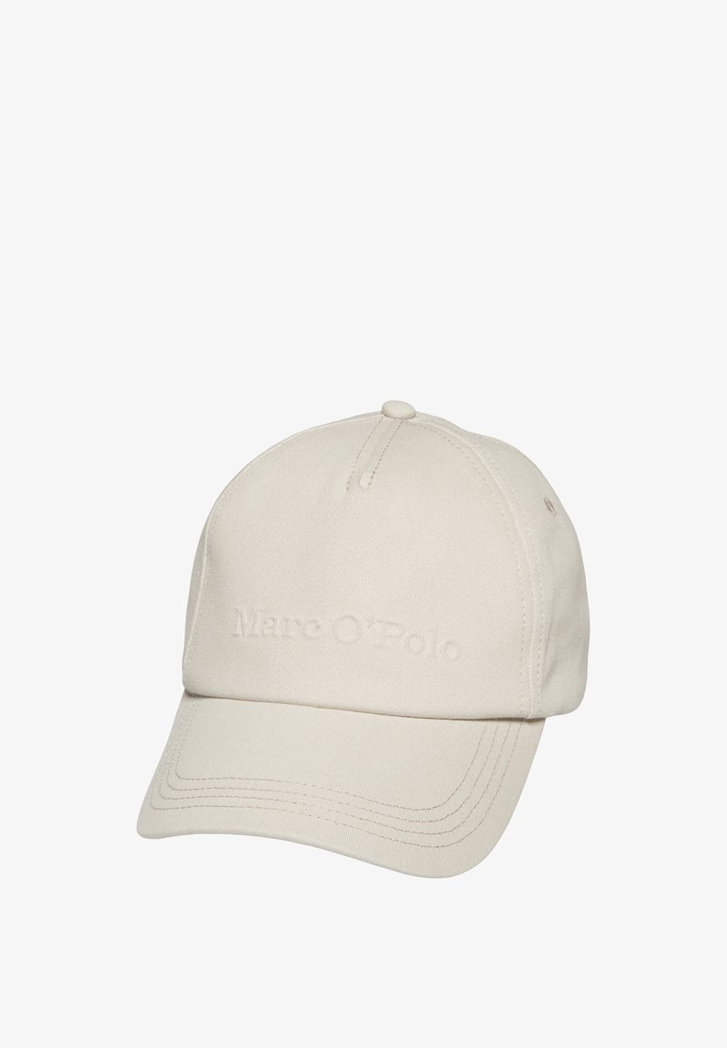 Beige baseball cap made from cotton, featuring an embossed logo, a curved brim, and stitching details on the visor and crown.