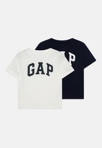 Du dušo trumpomis rankovėmis marškiniai balti ir tamsiai mėlyni, su ryškiu "GAP" logotipu. Lygi tekstūra, standartinio apvalaus kaklo dizainas.