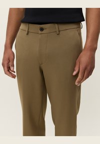 Brown, tailored trousers showcasing a smooth, textured fabric. Features a button closure and belt loops, with a straight leg design.