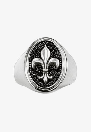 Silberner Siegelring mit erhabenem Fleur-de-Lis-Symbol auf einem strukturierten schwarzen ovalen Hintergrund.