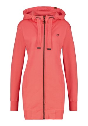 Sweat à capuche corail zippé avec un col haut, des cordons de serrage noirs, des poches latérales, des poignets côtelés et un petit logo en forme de cœur sur la poitrine. Tissu doux.