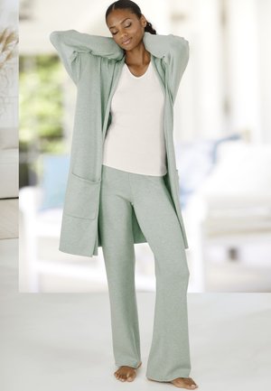 Light green long cardigan, matching fitted top, and flared pants in soft fabric. Features a spacious front pocket and relaxed fit.