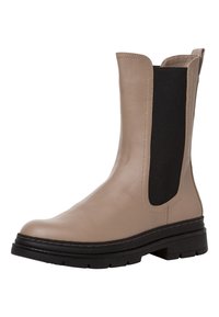 Bottines en cuir beige avec des panneaux latéraux élastiques noirs, petit talon carré, semelle texturée et détails de couture visibles.