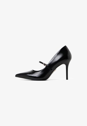 Black patent leather high heel shoe with pointed toe, featuring a strap with a small buckle and a slim stiletto heel.