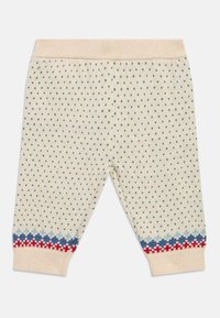 Πλεκτό παιδικό παντελόνι σε κρεμ χρώμα με πράσινες πουά, με μανσέτες σε μπλε και κόκκινo σχέδιο και ελαστική μέση. Μαλακή υφή.
