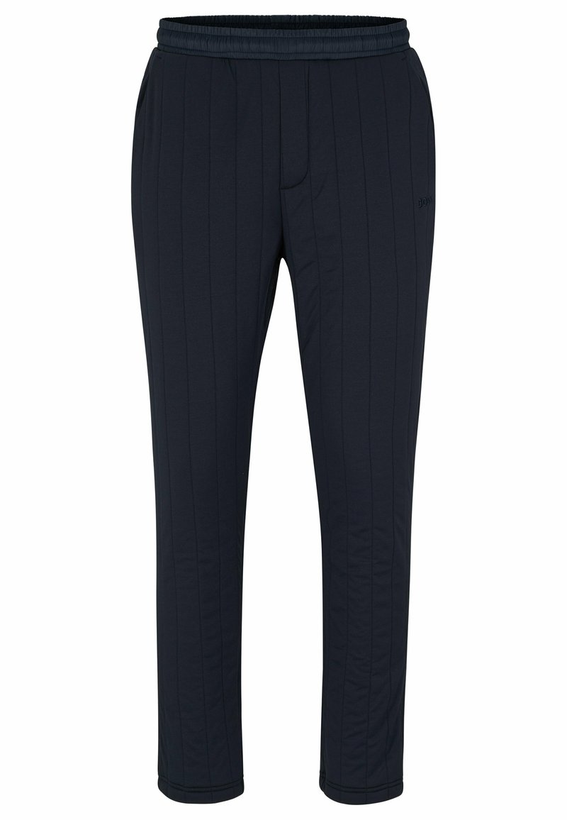 Pantalons de survêtement bleu marine avec des rayures verticales, taille élastique, poches latérales et coupe fuselée aux chevilles. Texture de tissu lisse.