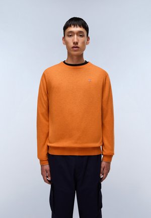 Orange crewneck sweater med struktureret stof. Har en sort halsudskæring og et lille broderet emblem på brystet.