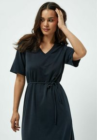 Dark navy dress made from a soft material, featuring a V-neck, short sleeves, and a waist tie for adjustable fit.