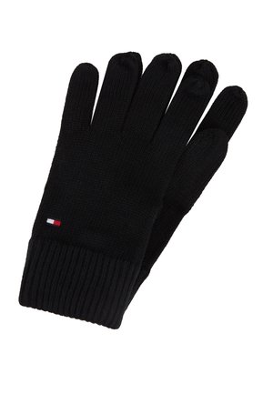 Gants en tricot noir avec des poignets côtelés et un petit logo rectangulaire rouge, blanc et bleu au poignet.