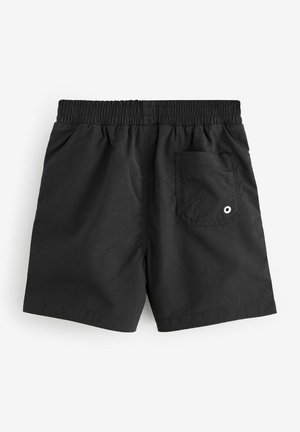 Shorts noirs avec une taille élastique. Conception simple avec une poche arrière dotée d'un œillet blanc. Tissu lisse et léger.