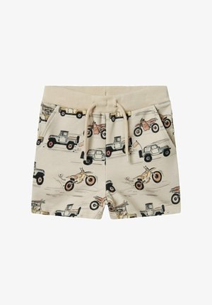 Beige shorts med et gentaget mønster af køretøjer og motorcykler. Elastisk talje med snor og sidelommer. Blød stofstruktur.