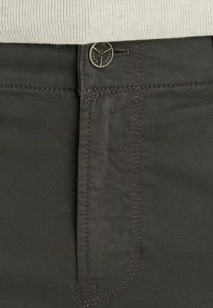 Dark gray trousers with a smooth texture. Features a button with engraved logo and visible stitching along pockets and seams.